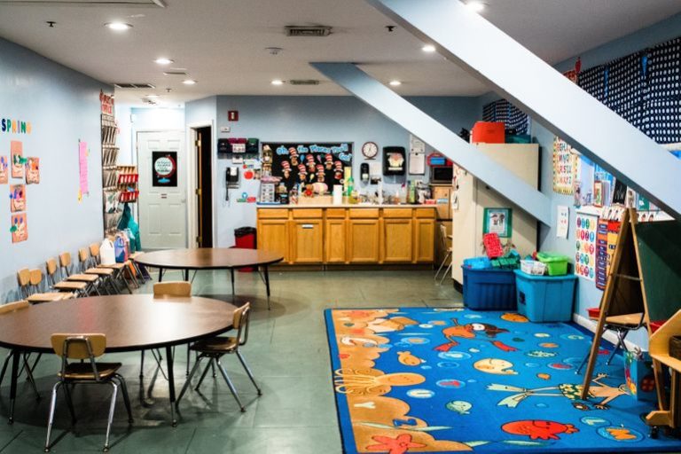 engaging design of nursery room with colorful and kid friendly floor mat and wall designs at a Childcare Serving Branford, Cheshire, Wallingford, CT