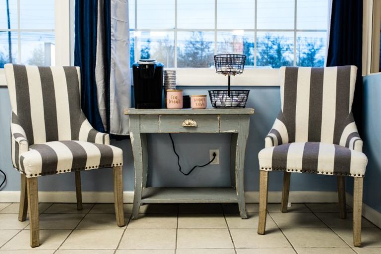 nice looking brown and white strife chair with table in the middle as waiting area at a Childcare Serving Branford, Cheshire, Wallingford, CT