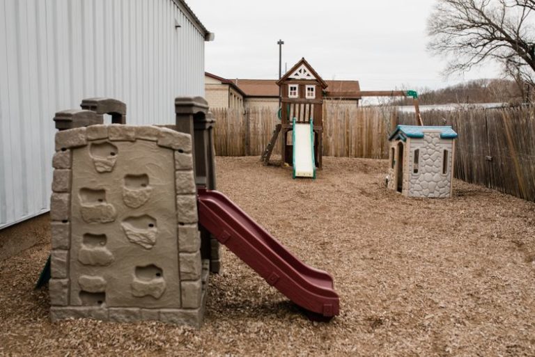 Plastic playhouse and slides without kids at a Childcare Serving Branford, Cheshire, Wallingford, CT